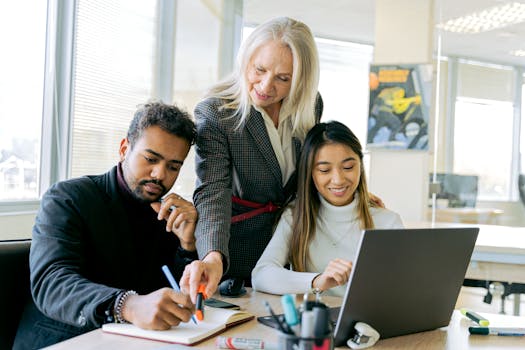 An adult team collaborating in an office environment, focusing on teamwork and diversity.