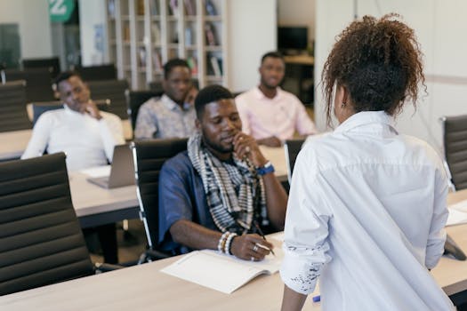 A group of professionals engaging in a training session in a modern office setting.